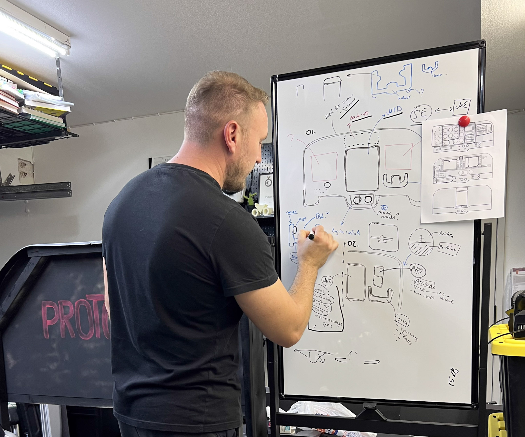 Dennis Schaefer sketching avionics layout concepts on a whiteboard